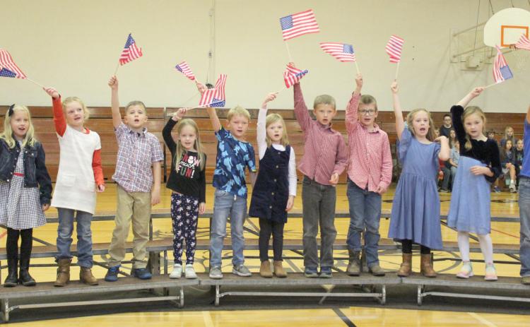 Mullen first graders sing “You’re a Grand Old Flag,” pictured l-r: Charlotte Connealy, Anna Ridenour, Tate Phillips, Aurora Polt, Jaxson Barnes, Meyer Vinton, Merick Lattin, Cooper Ourada, Kinley Crisp, Brogan Jewell, Kayden Evans. Gerri Peterson