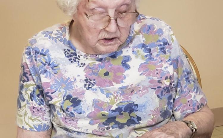 Minnie Mary Hamilton enjoying the Thomas County Herald.