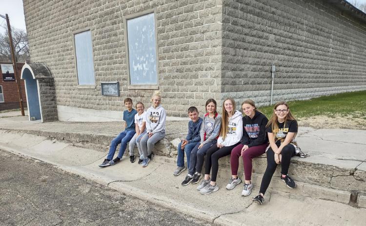 JH MYF kids in front of the Seneca Auditorium before their project last year, l-r: Alex Werner, Riley Hegland, Tierston Moore, Hunter Brown, Kalli Licking, Sydnee Cheever, Harper Andersen, Hope Miller. Dawn Mallory