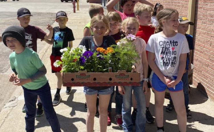 2nd graders plant flowers at elementary