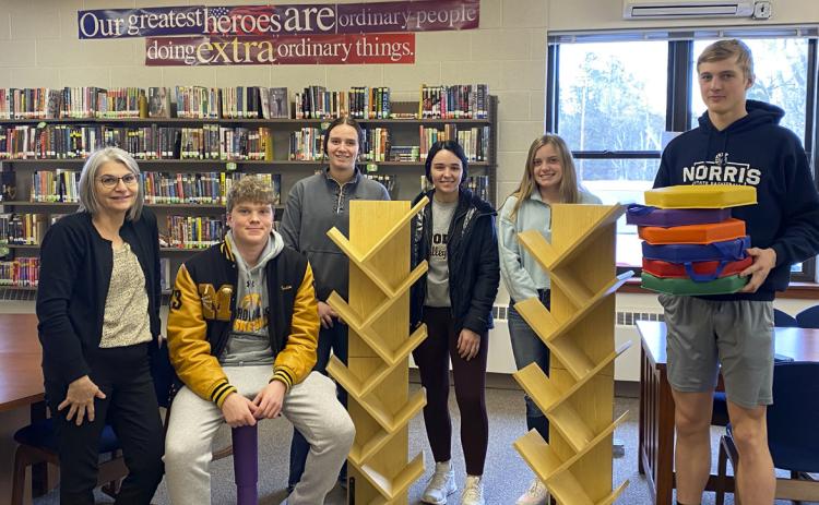 Mullen High School National Honor Society members used the Scholastic Bookfair money that they raised to purchase bookshelves, floor seating and a wobble chair for the school libraries. Pictured l-r: Media Specialist Mrs. Licking, Ethan Hardin (sitting on the wobble chair), Jadyn Andersen, Bella Brown, Lauren Schoonveld, Clayton Moore (holding the floor seats). NHS members not pictured: Deacon DeNaeyer, Chase Gracey, Ashlyn Simonson. Kara Connealy
