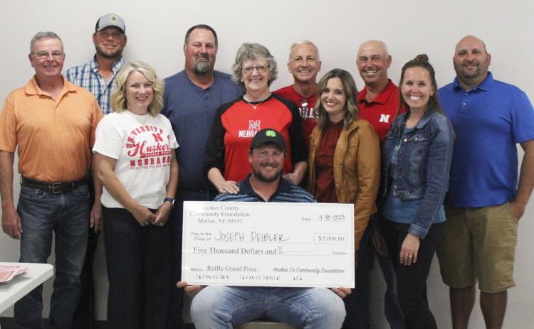 Joseph Deibler was the big winner at the Hooker County Community Foundation Raffle Saturday night. He is pictured with the Hooker County Community Foundation Board of Directors, back l-r: Tim Andersen, Larry Ridenour, Scott Jones, Ron Boyer, Casey Phillips. Front: Kirk Jacobs, Barb Svoboda, Mary Lou Harding, Kara Connealy, Gerri Peterson. Not pictured: George Vinton. Megan Andersen
