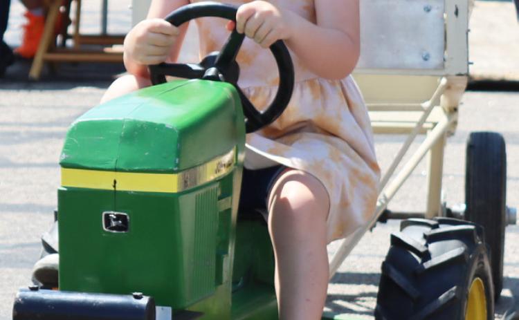Wrenley Call tries out pedal tractor pulling. Gerri Peterson
