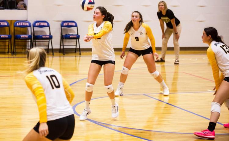 Allie Boyer passes up the ball at the Arthur triangular while teammates Taylor Svoboda, Jordyn McDowell and Shelby Welsh and Head Coach Jennifer Moore look on. Megan Andersen