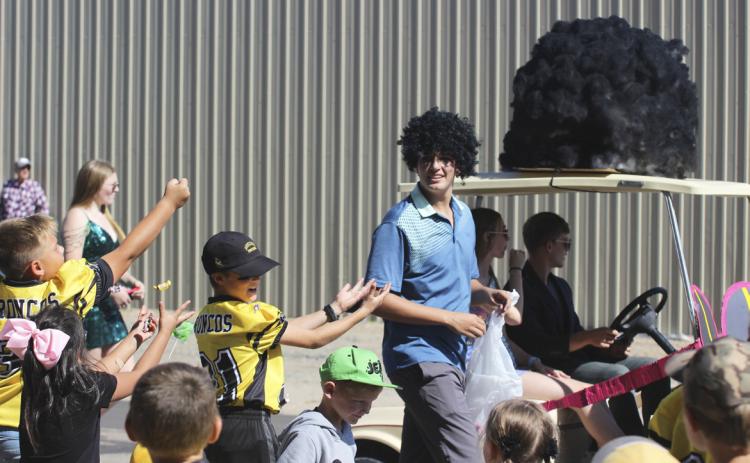 MHS sophomore Jacob Walker watches as his sister Natalee Walker catches the candy he threw her way during the Homecoming parade last Friday, Sept. 29.