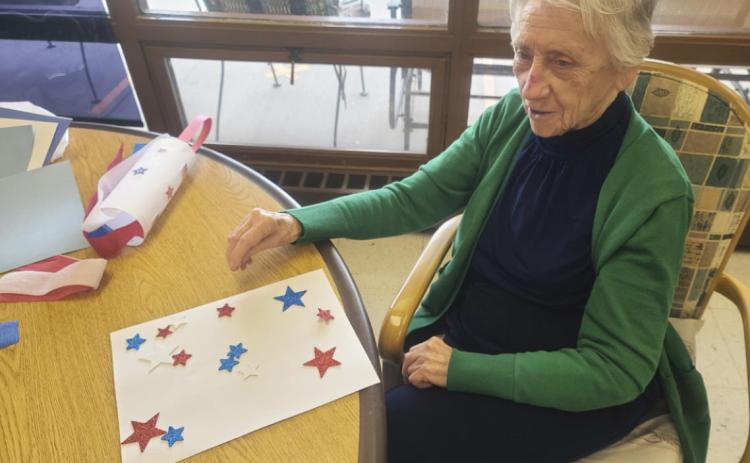 Wanda Mackley working on the windsock craft.