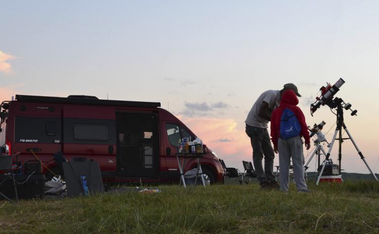 Astrophotographer Kumar Challa from St. Louis shows some of his work to a budding astronomer on the final night of the Nebraska Star Party. Carson Vaughan